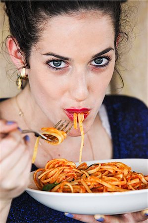 fork with noodles - Woman eating plate of pasta Stock Photo - Premium Royalty-Free, Code: 649-06352938