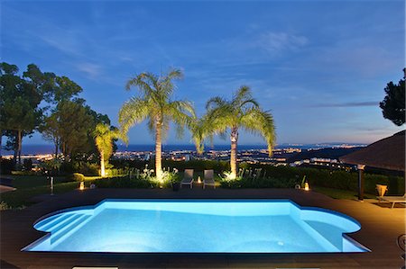 swimming pool night palm tree - Illuminated pool and palm trees Stock Photo - Premium Royalty-Free, Code: 649-06353379