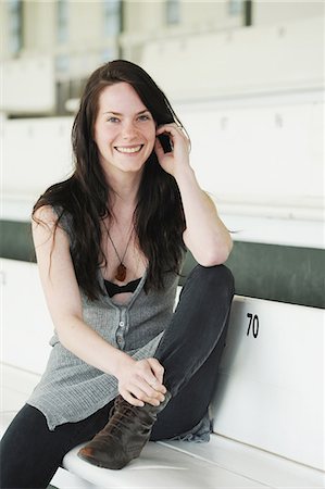 Femme souriante, assis sur un banc Photographie de stock - Premium Libres de Droits, Code: 649-06400642