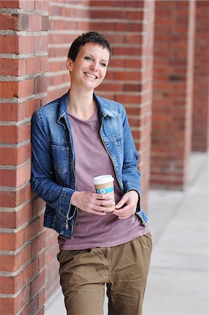 food, european - Smiling woman holding cup of coffee Stock Photo - Premium Royalty-Free, Code: 649-06400669