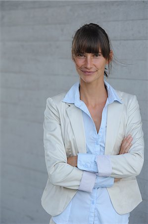 suit pose - Smiling businesswoman with crossed arms Stock Photo - Premium Royalty-Free, Code: 649-06400663