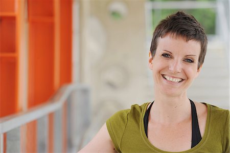 short hair - Smiling woman walking on city street Stock Photo - Premium Royalty-Free, Code: 649-06400678