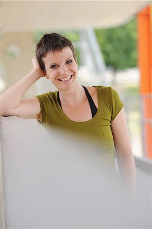 Smiling woman leaning on bar Stock Photo - Premium Royalty-Free, Code: 649-06400679