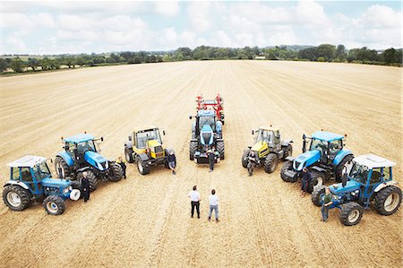 Farmers with tractors in crop field Stock Photo - Premium Royalty-Free, Code: 649-06401222