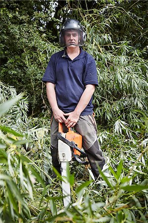 power tool work man - Worker holding chainsaw in forest Stock Photo - Premium Royalty-Free, Code: 649-06401231