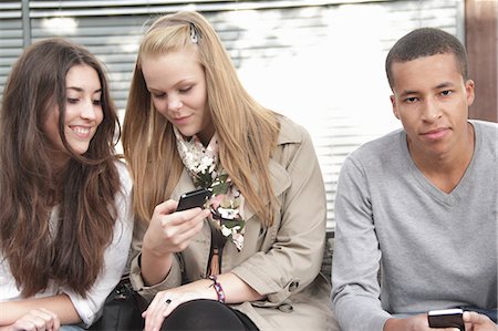 Teenagers using cell phones outdoors Stock Photo - Premium Royalty-Free, Code: 649-06401283