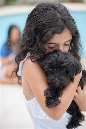simsearch:649-06401393,k - Smiling girl holding puppy Stock Photo - Premium Royalty-Free, Code: 649-06401394