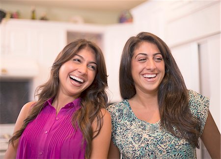 Sisters laughing together in kitchen Stock Photo - Premium Royalty-Free, Code: 649-06401422