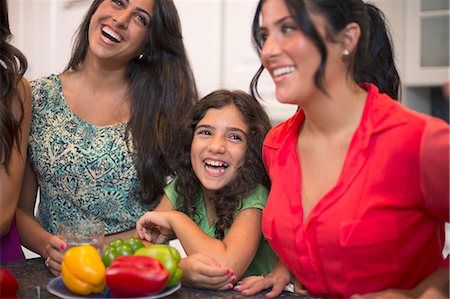 Sisters laughing together in kitchen Stock Photo - Premium Royalty-Free, Code: 649-06401423