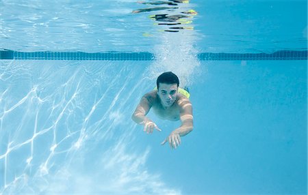 swimming pool photos - Teenage boy swimming underwater Stock Photo - Premium Royalty-Free, Code: 649-06401434