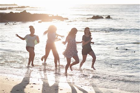 photos of mixed race teenage girls - Women running together on beach Stock Photo - Premium Royalty-Free, Code: 649-06432375