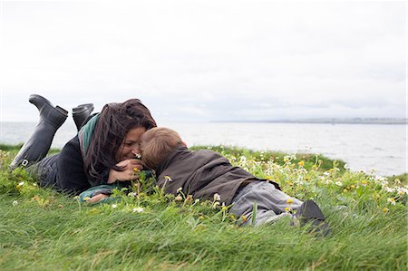 Mother and son laying in grassy field Stock Photo - Premium Royalty-Free, Code: 649-06432455