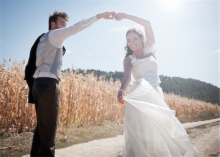 smiling bride - Newlywed couple dancing outdoors Stock Photo - Premium Royalty-Free, Code: 649-06432541