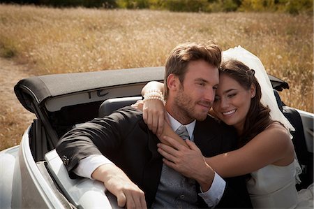 simsearch:649-06432569,k - Newlywed couple hugging in convertible Foto de stock - Sin royalties Premium, Código: 649-06432554