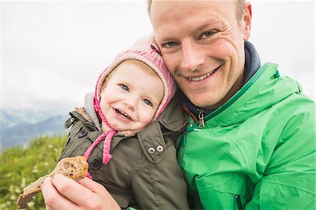 Father holding daughter outdoors Stock Photo - Premium Royalty-Free, Code: 649-06432611