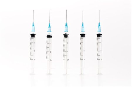 Row of blue syringes Stock Photo - Premium Royalty-Free, Code: 649-06432623