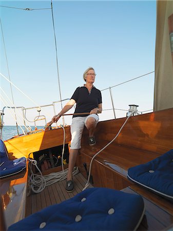 simsearch:614-00602699,k - Older woman steering sailboat Stock Photo - Premium Royalty-Free, Code: 649-06432710