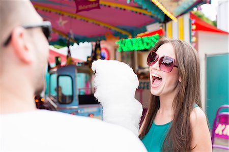 europe theme park - Woman eating cotton candy at fair Stock Photo - Premium Royalty-Free, Code: 649-06432908