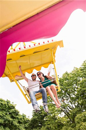 europe theme park - Couple riding amusement park ride Stock Photo - Premium Royalty-Free, Code: 649-06432910