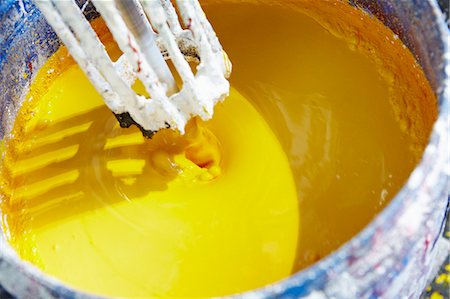 Vat of yellow paint being mixed Stock Photo - Premium Royalty-Free, Code: 649-06433372