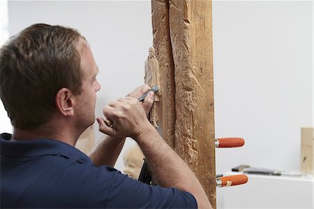 Worker chiseling figure from wood Stock Photo - Premium Royalty-Free, Code: 649-06433457