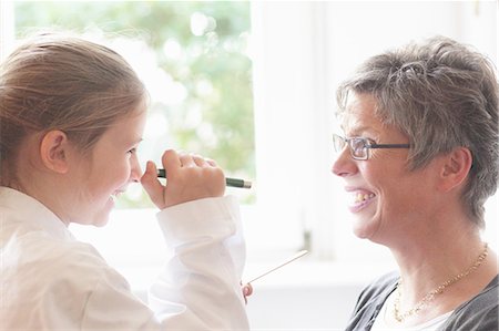 Girl playing doctor with grandmother Stock Photo - Premium Royalty-Free, Code: 649-06433460