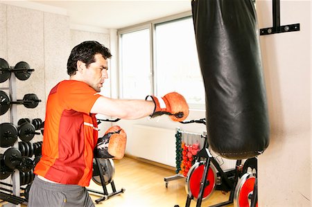 punch - Man using punching bag at gym Stock Photo - Premium Royalty-Free, Code: 649-06433567