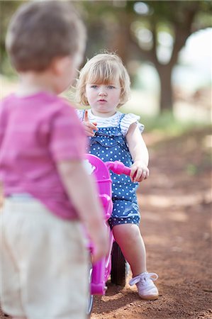 Toddlers playing on dirt road Stock Photo - Premium Royalty-Free, Code: 649-06488445