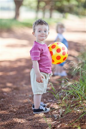 full length - Toddler boy with ball on dirt road Stock Photo - Premium Royalty-Free, Code: 649-06488481