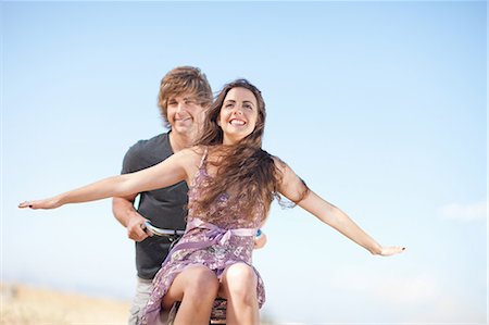 people blue sky - Couple riding bicycle outdoors Stock Photo - Premium Royalty-Free, Code: 649-06488519