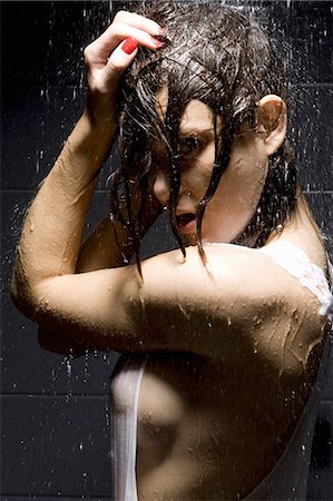 Woman showering in shirt Stock Photo - Premium Royalty-Free, Code: 649-06488627