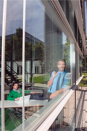 Businessmen in office behind window Stock Photo - Premium Royalty-Free, Code: 649-06488664