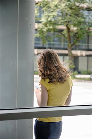 simsearch:649-06041170,k - Woman leaning against window Stock Photo - Premium Royalty-Free, Code: 649-06488675