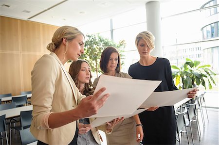 Businesswomen examining papers Stock Photo - Premium Royalty-Free, Code: 649-06488679