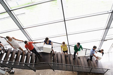 people working together - People passing boxes up stairs Stock Photo - Premium Royalty-Free, Code: 649-06488773