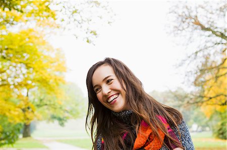 portrait looking away - Smiling woman standing in forest Stock Photo - Premium Royalty-Free, Code: 649-06488903