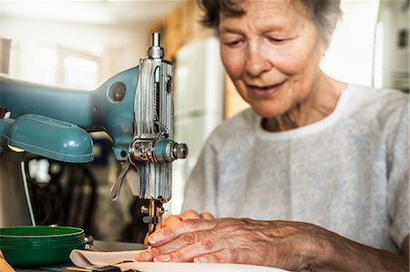 sewing - Older woman working on sewing machine Stock Photo - Premium Royalty-Free, Code: 649-06488962