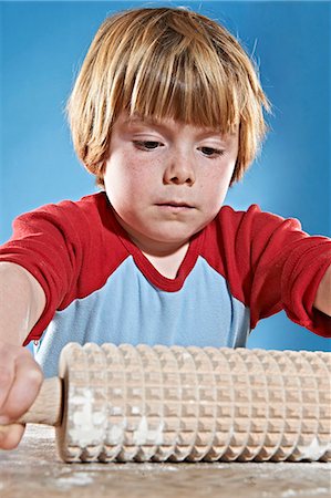 fun with flour - Boys rolling out dough with studded pin Stock Photo - Premium Royalty-Free, Code: 649-06489124