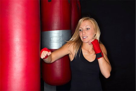 Boxer training with punching bag Stock Photo - Premium Royalty-Free, Code: 649-06489192
