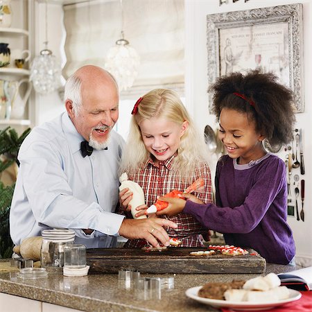 Family baking Christmas cookies together Stock Photo - Premium Royalty-Free, Code: 649-06489287