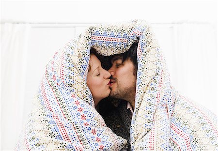 Couple kissing under duvet blanket Stock Photo - Premium Royalty-Free, Code: 649-06489378