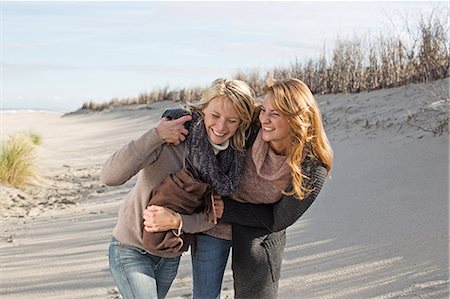 friends holidays beach - Smiling women walking on beach Stock Photo - Premium Royalty-Free, Code: 649-06489757