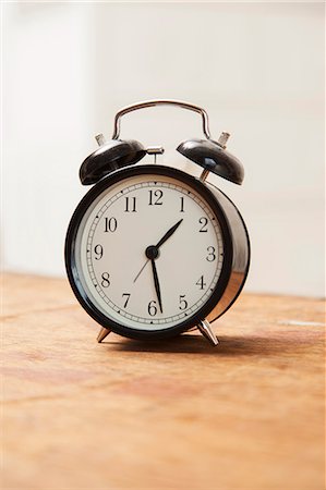 Alarm clock on wooden table Stock Photo - Premium Royalty-Free, Code: 649-06490058