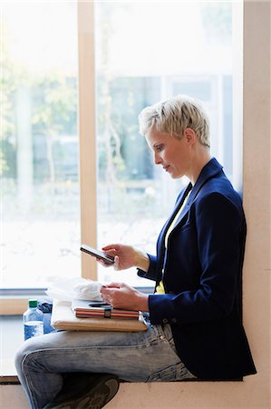 Woman using cell phone on lunch break Stock Photo - Premium Royalty-Free, Code: 649-06532709