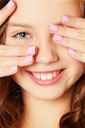 Smiling girl with polka dot manicure Stock Photo - Premium Royalty-Free, Code: 649-06533069