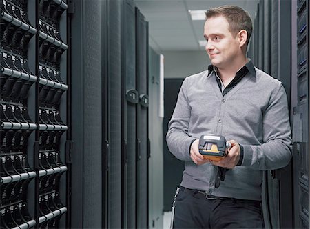 people and technology - Man working in server room Stock Photo - Premium Royalty-Free, Code: 649-06533294
