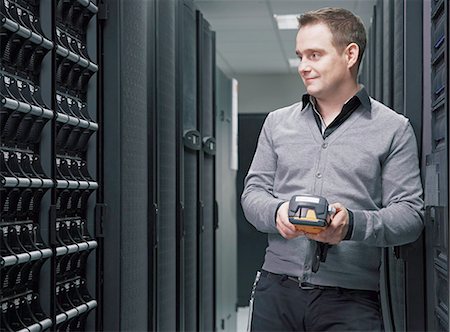 Man working in server room Stock Photo - Premium Royalty-Free, Code: 649-06533294