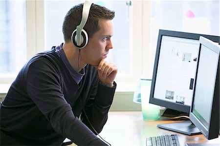 electronics computer technology - Man using computers at desk Stock Photo - Premium Royalty-Free, Code: 649-06533310