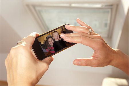 skype - Woman examining picture on cell phone Stock Photo - Premium Royalty-Free, Code: 649-06533540