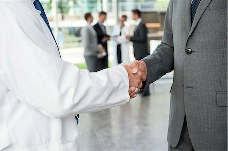 doctors with person in a suit - Businessman and doctor shaking hands Stock Photo - Premium Royalty-Free, Code: 649-06622066